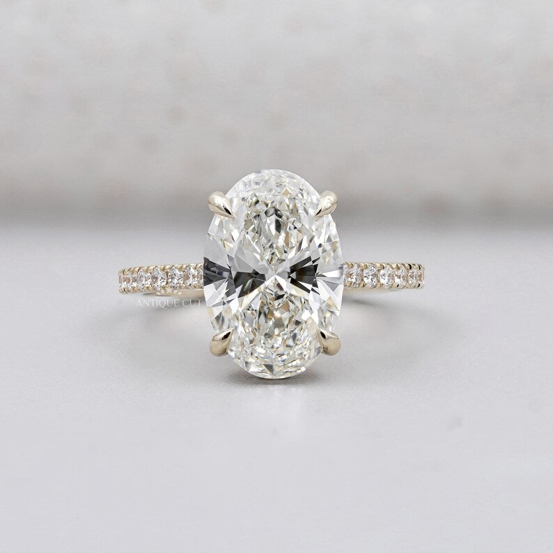 Hidden halo oval engagement ring yellow gold pave diamond band