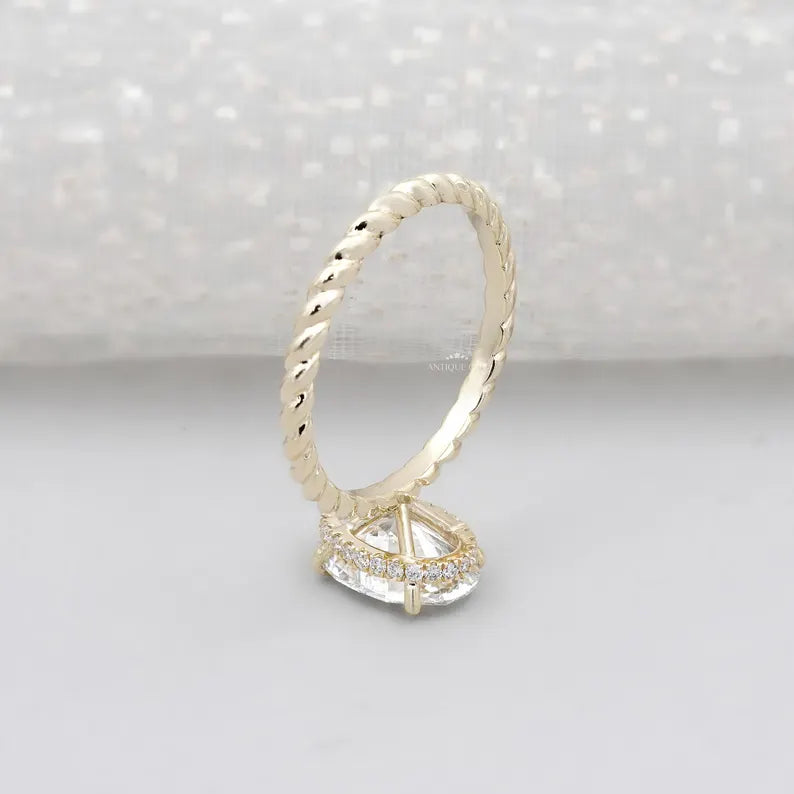 Twisted gold band engagement ring oval diamond