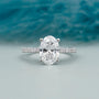 Oval cut diamond engagement ring with pave band in white gold