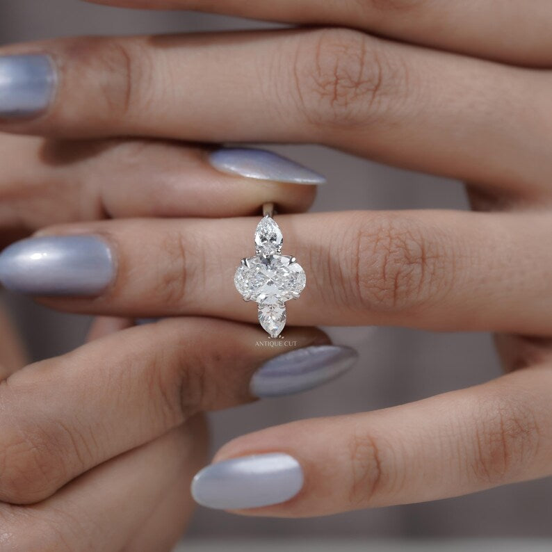 Luxury oval diamond three stone ring in polished white gold
