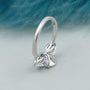 White gold three stone ring with oval center diamond