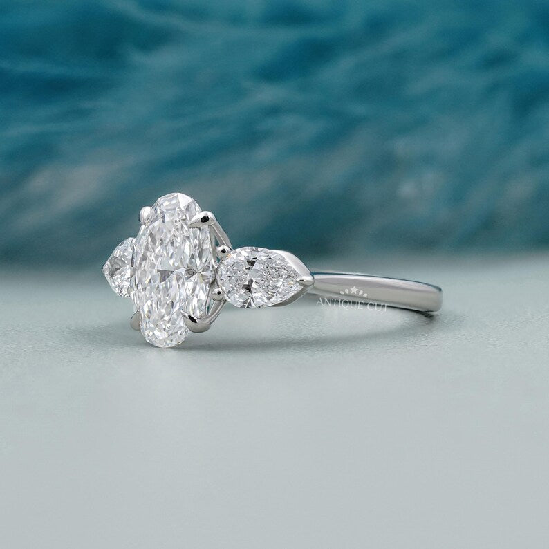 Oval diamond three stone ring with side diamonds white gold