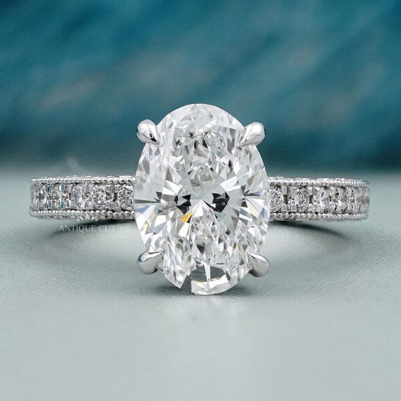 Oval cut engagement ring with pave diamond band