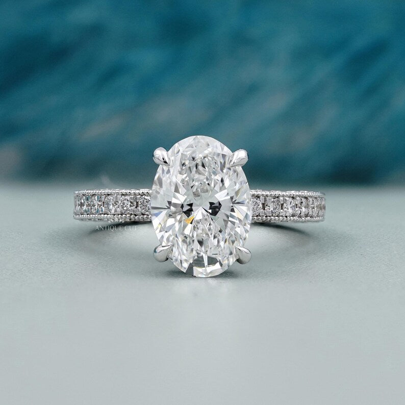 Oval cut engagement ring with pave diamond band