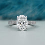 Oval cut engagement ring with pave diamond band