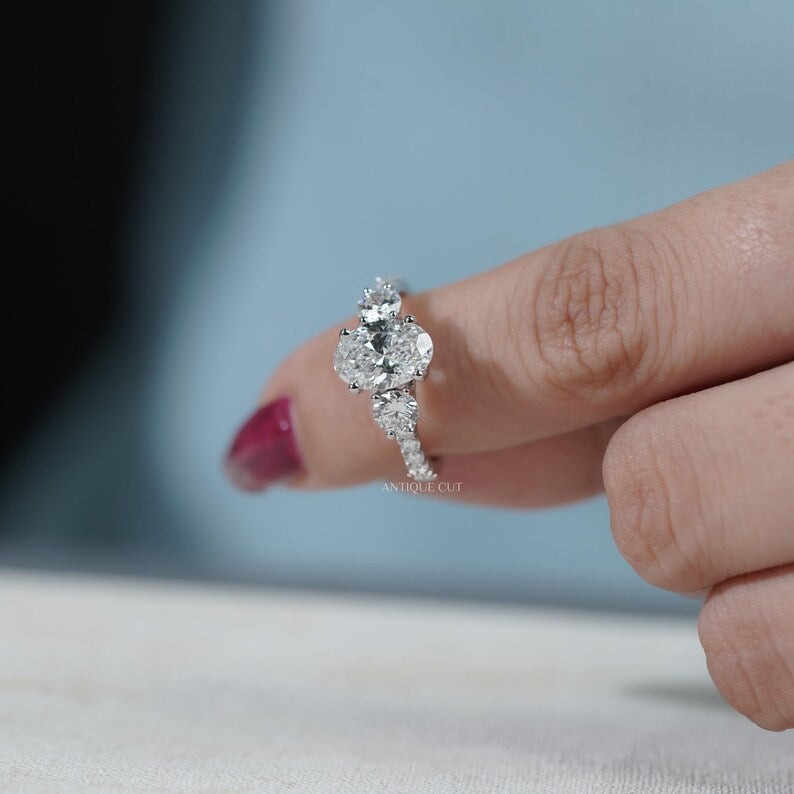 Classic oval engagement ring with pave white gold band