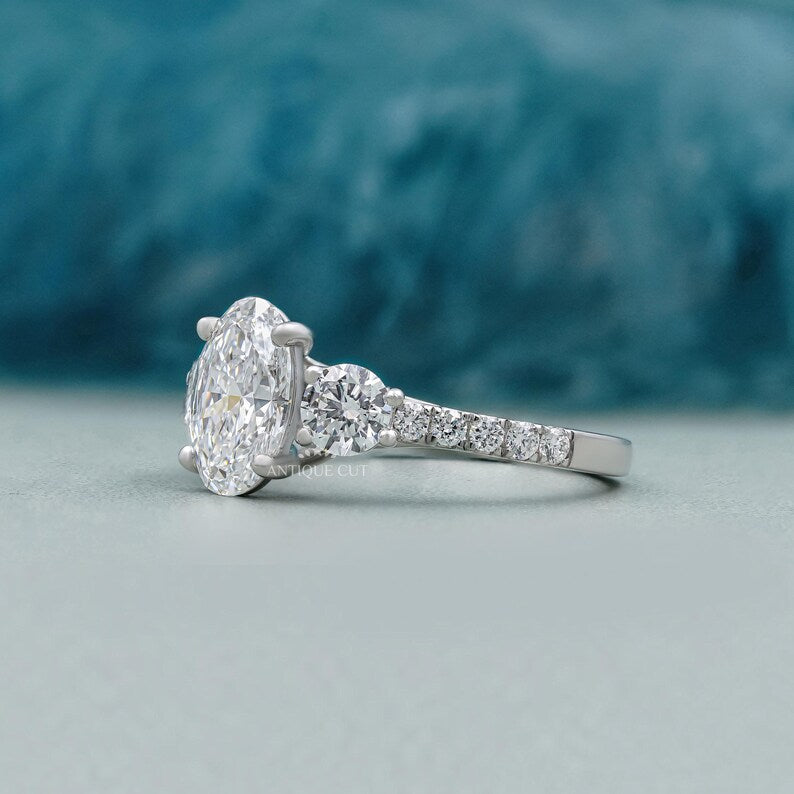 Oval solitaire diamond ring with sparkling pave band