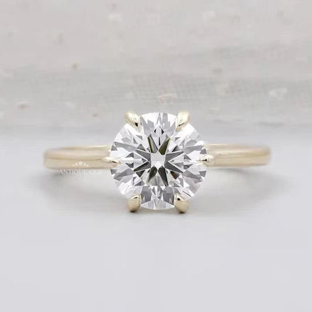 Round cut engagement ring with six prong solitaire setting