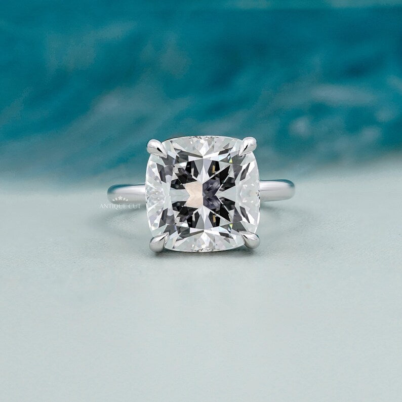 Cushion cut hidden halo engagement ring in white gold