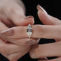 Step cut emerald diamond ring with bezel setting in yellow gold