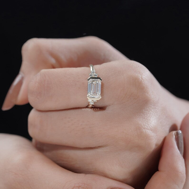 Modern bezel set emerald cut diamond ring horizontal orientation