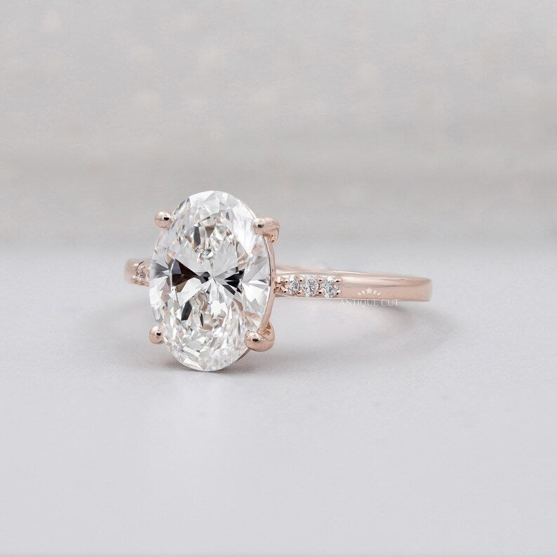 Rose gold oval cut diamond ring with pave halo engagement