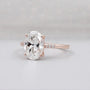 Rose gold oval cut diamond ring with pave halo engagement