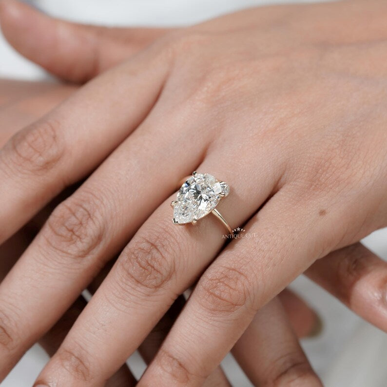 Ethical lab grown pear diamond ring yellow gold side stones