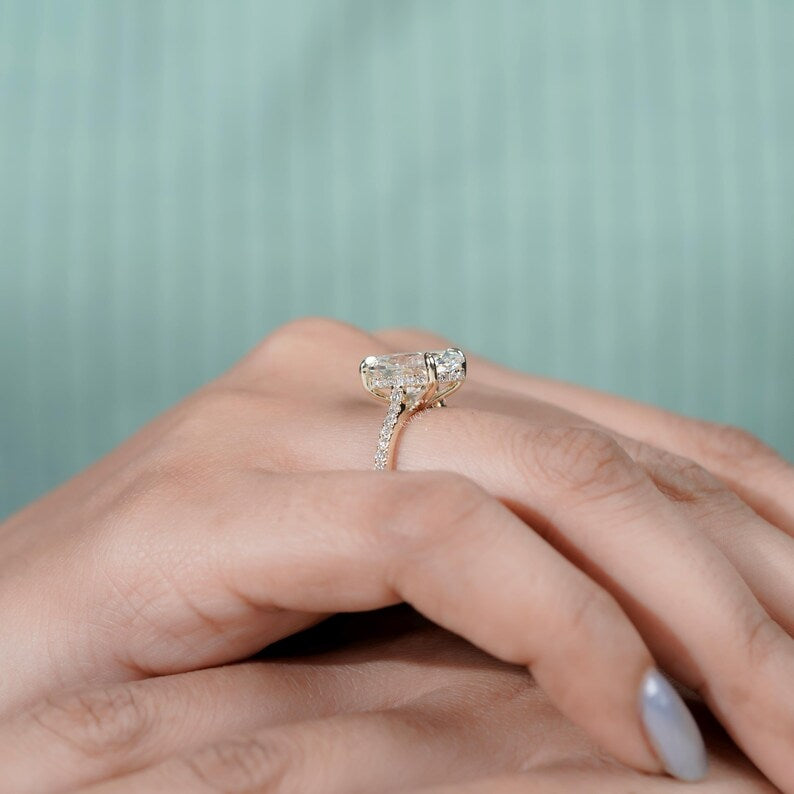 Refined oval engagement ring with hidden halo yellow gold