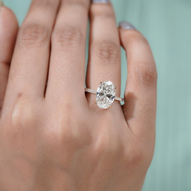 Statement oval cut diamond ring hidden halo pave gold