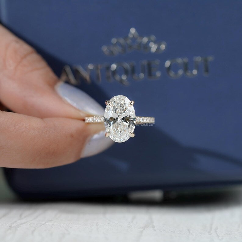 Modern oval engagement ring with hidden halo pave band