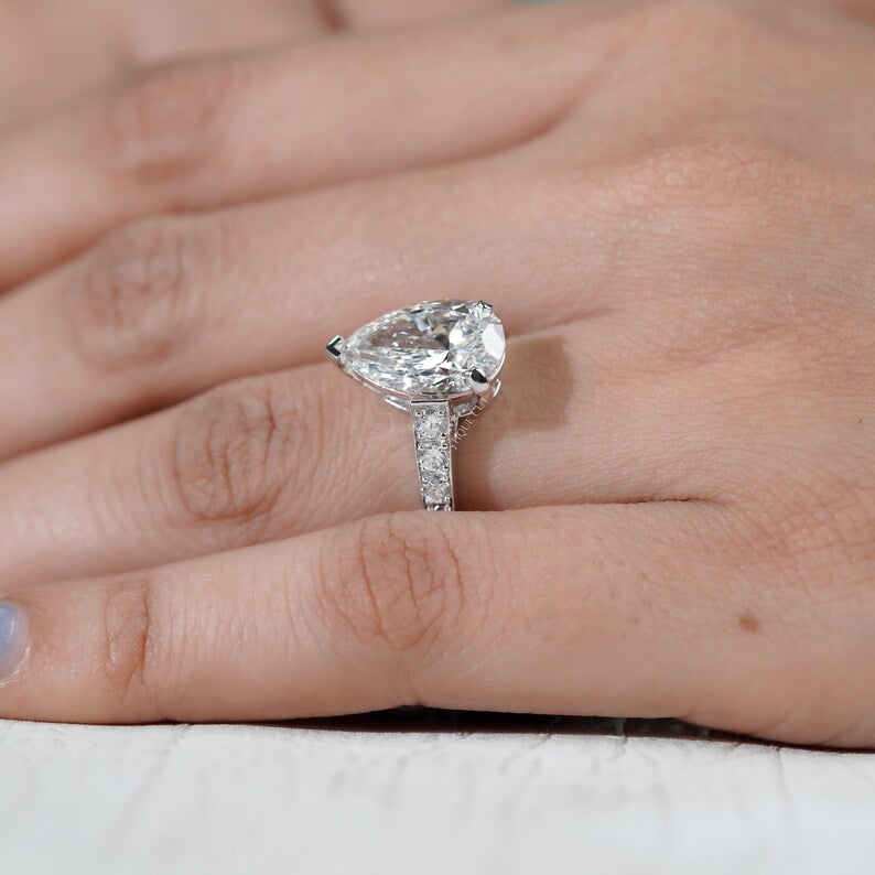 Contemporary pear cut diamond ring white gold pave design