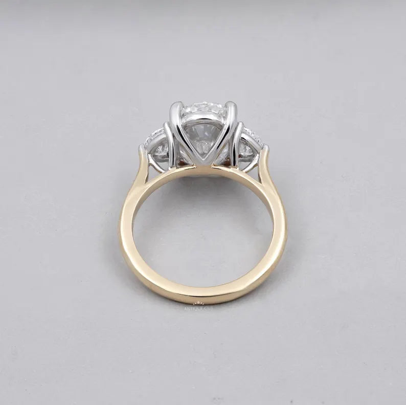 Elegant oval three stone engagement ring yellow gold design