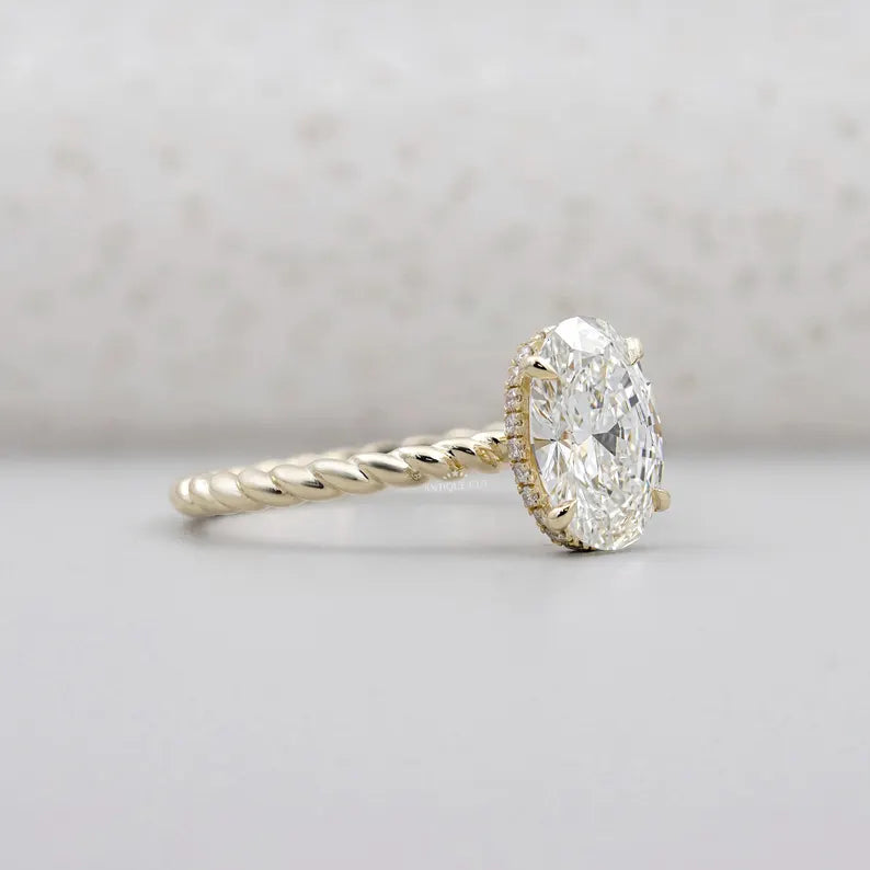 Yellow gold oval diamond ring with hidden halo