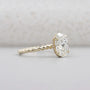 Yellow gold oval diamond ring with hidden halo