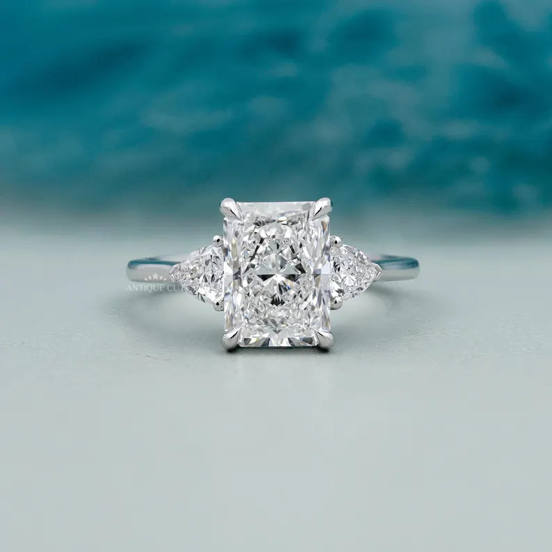 Radiant cut diamond three stone engagement ring white gold