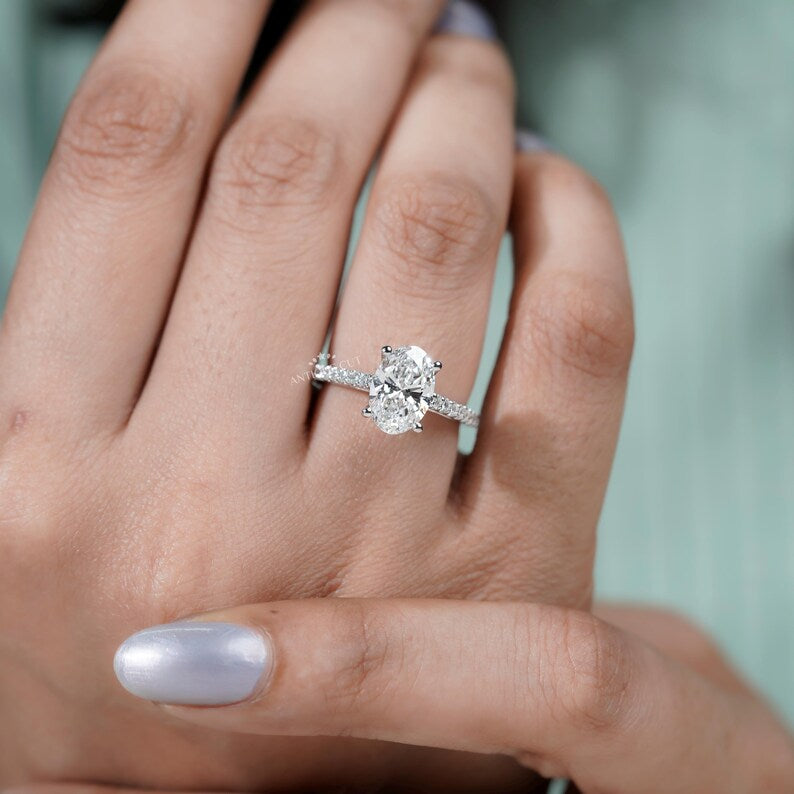 Sophisticated oval engagement ring with diamond pave band