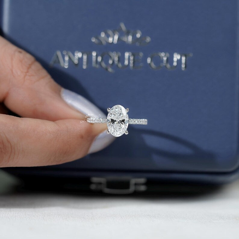 Oval diamond ring with sparkling round pave diamonds on band