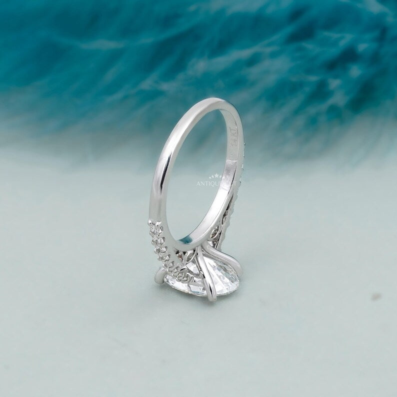 White gold oval cut diamond ring with delicate pave setting