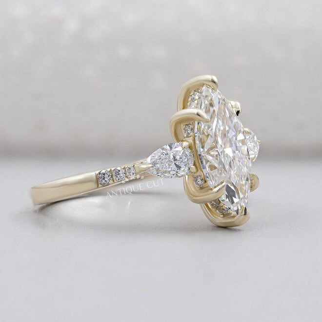 Three stone marquise diamond ring yellow gold