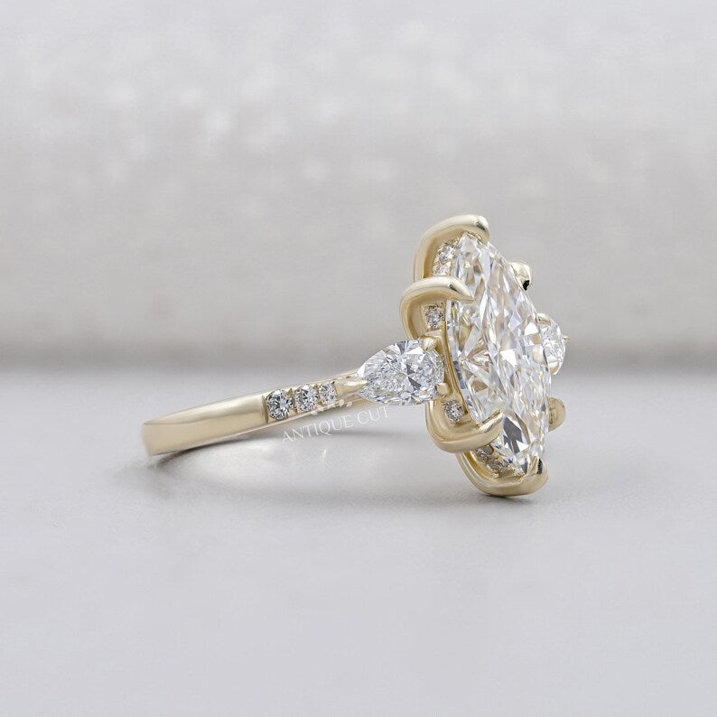 Three stone marquise diamond ring yellow gold