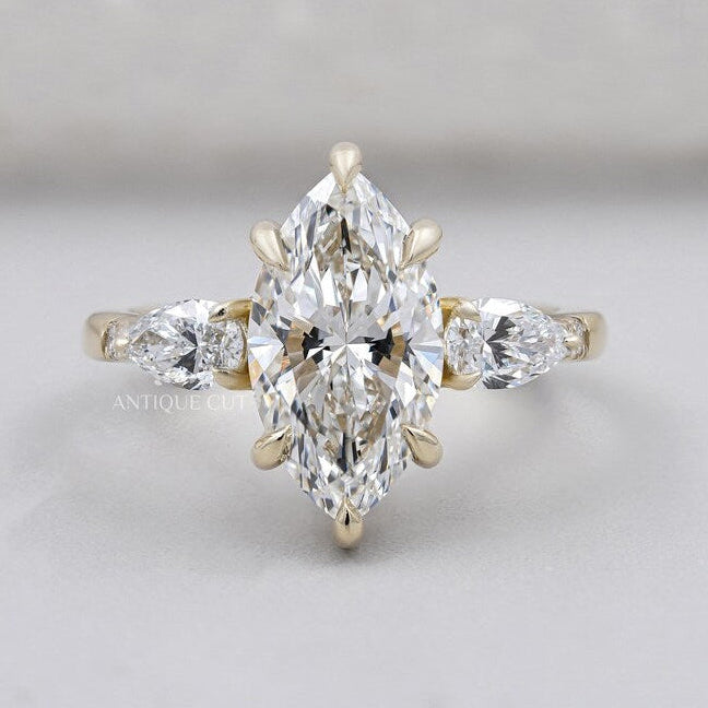 Marquise cut engagement ring with pear side stones
