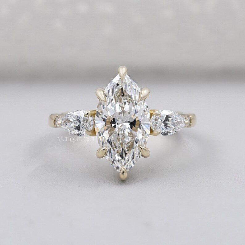 Marquise cut engagement ring with pear side stones