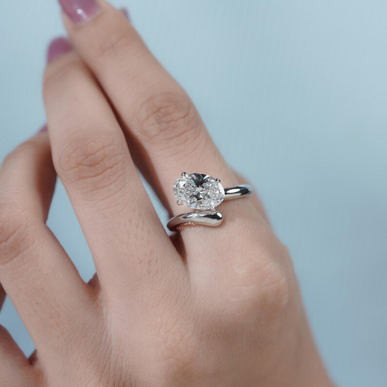 Unique bypass gold ring with oval diamond