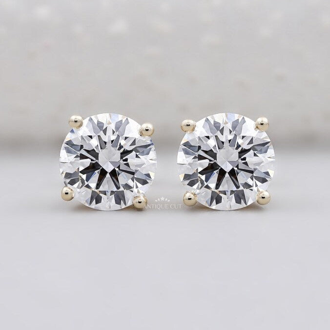 Round cut diamond stud earrings yellow gold