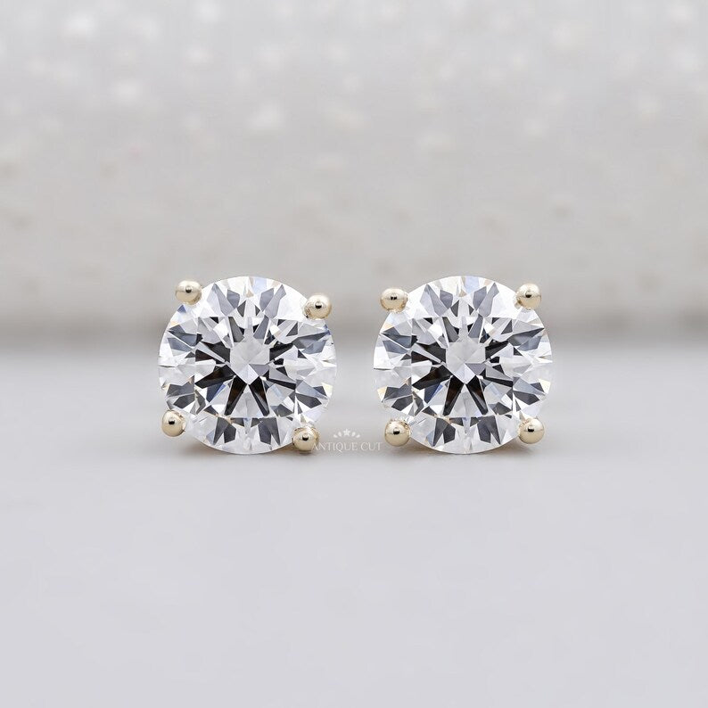 Round cut diamond stud earrings yellow gold