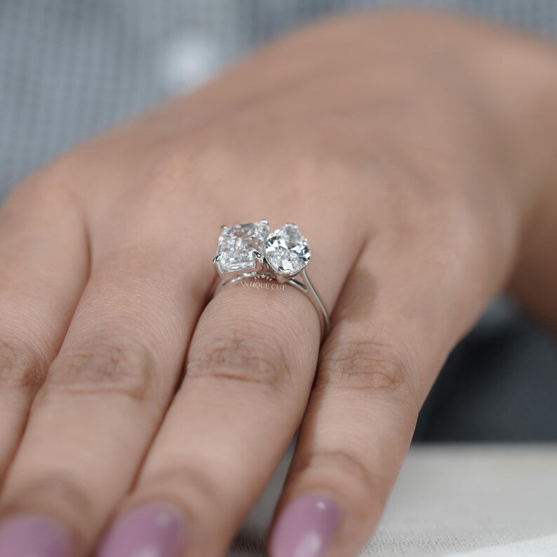 Modern toi et moi ring emerald and marquise diamonds