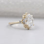 Oval diamond ring with floral halo yellow gold