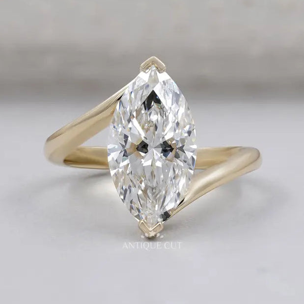 Marquise cut engagement ring with bypass setting