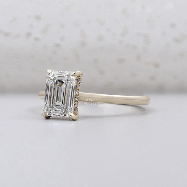 Hidden halo ring emerald cut side view