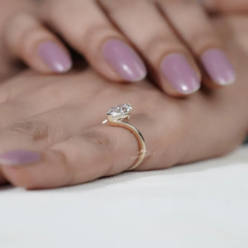 V-shaped prongs holding marquise diamond