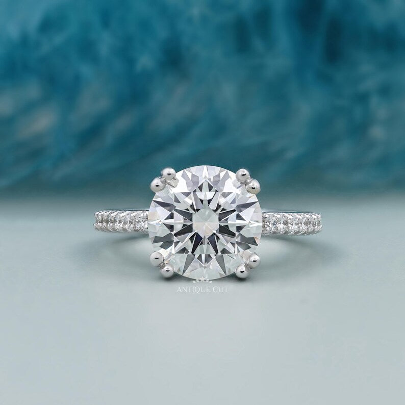 round cut engagement ring with pave diamond band