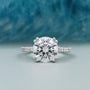 round cut engagement ring with pave diamond band