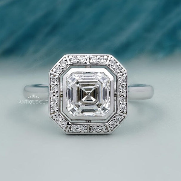 asscher cut diamond ring with bezel set halo