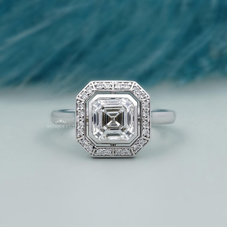asscher cut diamond ring with bezel set halo