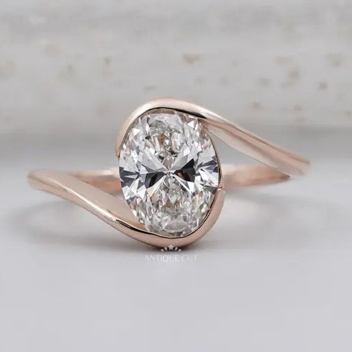 half bezel oval engagement ring in rose gold