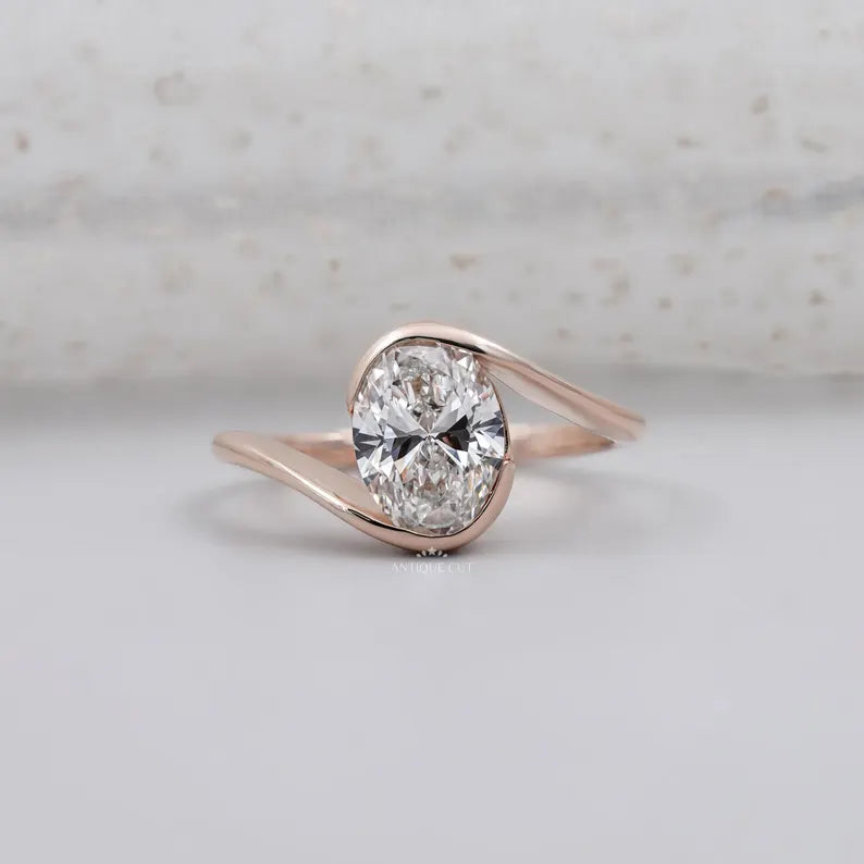 half bezel oval engagement ring in rose gold