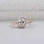 half bezel oval engagement ring in rose gold