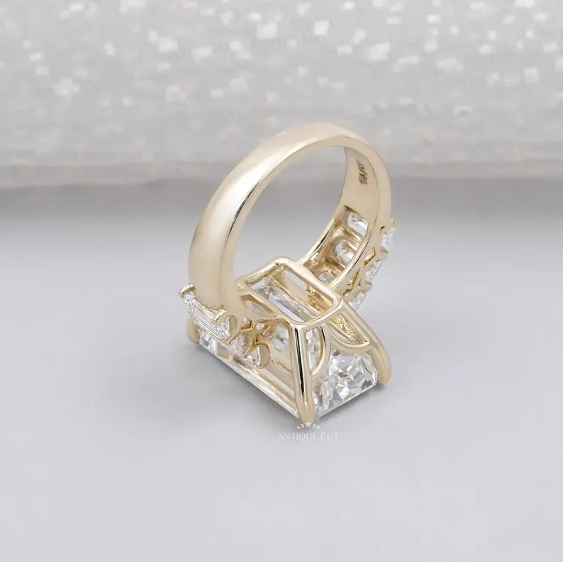 Elegant emerald cut center diamond flanked by tapered stones