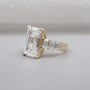 Yellow gold engagement ring with emerald cut center stone